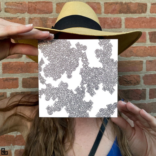 Photo of a human holding this specific LLLinked square. The lines of LLLinked are drawn by hand. Each square is 6"x6", cut, labeled, signed, and stamped by hand. Each LLLinked square has a unique QR code/RFID label. No two squares are the same. Owners can register and connect with other owners at LLLinked.art.