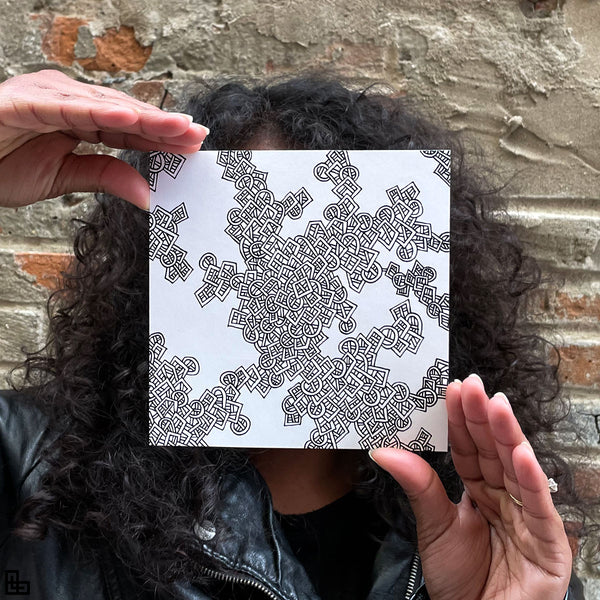 Photo of a human holding this specific LLLinked square. The lines of LLLinked are drawn by hand. Each square is 6"x6", cut, labeled, signed, and stamped by hand. Each LLLinked square has a unique QR code/RFID label. No two squares are the same. Owners can register and connect with other owners at LLLinked.art.
