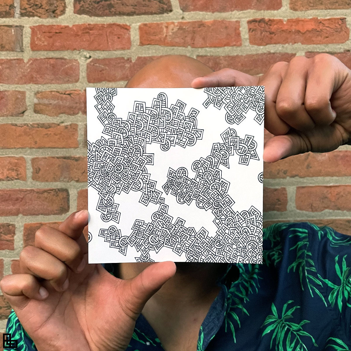 Photo of a human holding this specific LLLinked square. The lines of LLLinked are drawn by hand. Each square is 6"x6", cut, labeled, signed, and stamped by hand. Each LLLinked square has a unique QR code/RFID label. No two squares are the same. Owners can register and connect with other owners at LLLinked.art.