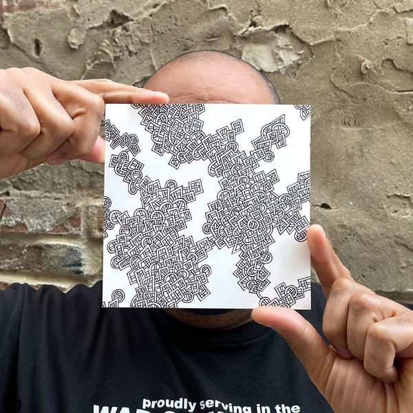 Photo of a human holding this specific LLLinked square. The lines of LLLinked are drawn by hand. Each square is 6"x6", cut, labeled, signed, and stamped by hand. Each LLLinked square has a unique QR code/RFID label. No two squares are the same. Owners can register and connect with other owners at LLLinked.art.