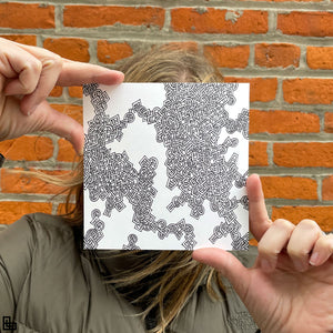 Photo of a human holding this specific LLLinked square. The lines of LLLinked are drawn by hand. Each square is 6"x6", cut, labeled, signed, and stamped by hand. Each LLLinked square has a unique QR code/RFID label. No two squares are the same. Owners can register and connect with other owners at LLLinked.art.